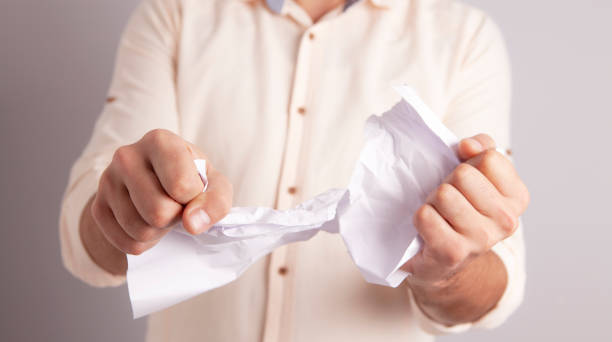 istock businessman hand paper tear 1083995824
