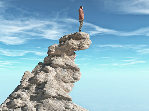 A man standing on a stone cliff.  Success concept.
