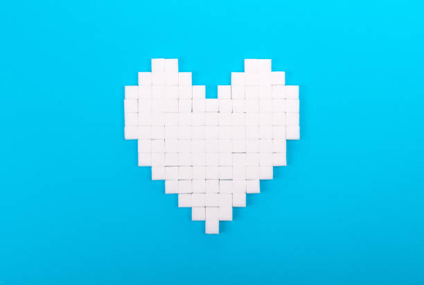 istock Heart of sugar cubes, blue background 1084019546