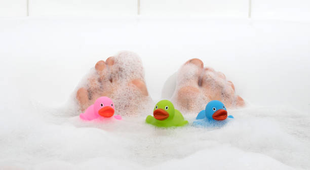 istock Men's feet in a bathtub, selective focus on toes 1084020876