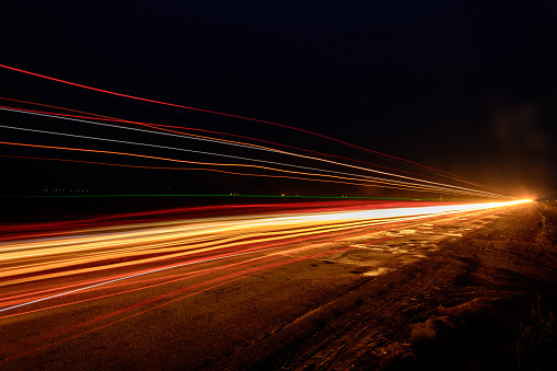 Photos of Ukrainian roads under the evening sky, on which cars are moving and blurring the way with their light
