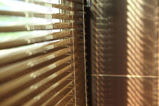 istock blinds in home with sunlight on the window 1084024778