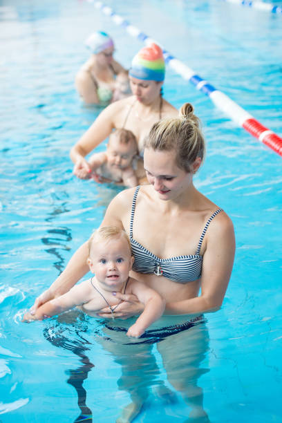 istock a small child with his mother in the pool 1084028994