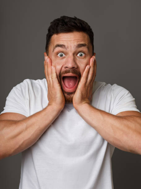 istock Surprised stunned emotional man with hands on cheeks 1084031488