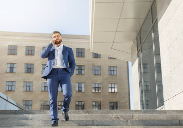 istock Businessman talking on mobile phone on walk 1084031524