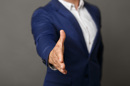 Handshake. Unrecognizable confident businessman stretching his hand for greeting