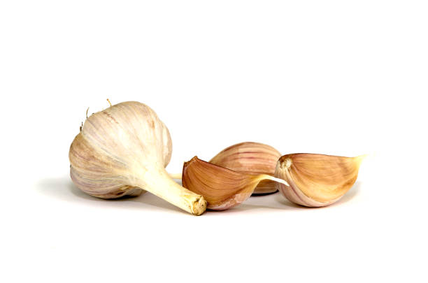istock Brown garlic cloves isolated on white background. 1084036662