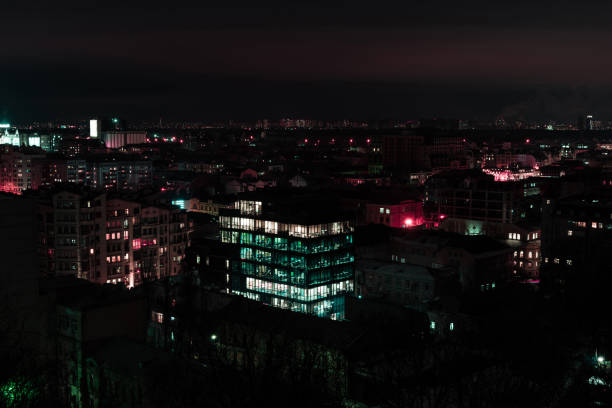 istock dark cityscape at night with illuminated windows 1084040478