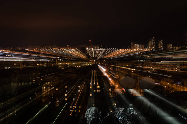 istock night cityscape with blurred bright illumination from windows 1084040618