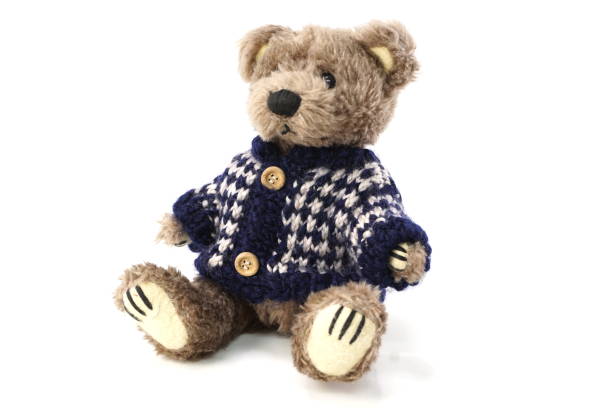 istock cute teddy bear with Sweater cloth isolated on white background 1084042794