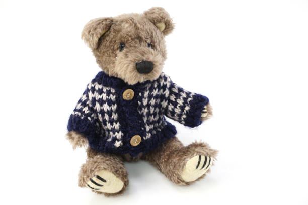 istock cute teddy bear with Sweater cloth isolated on white background 1084042818