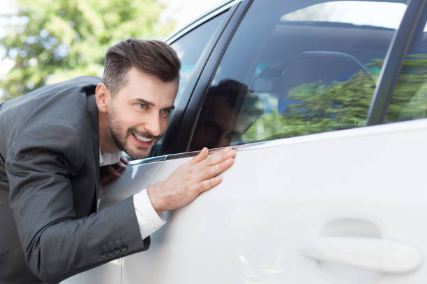 istock Business man obsessing about cleanliness of car 1084043170
