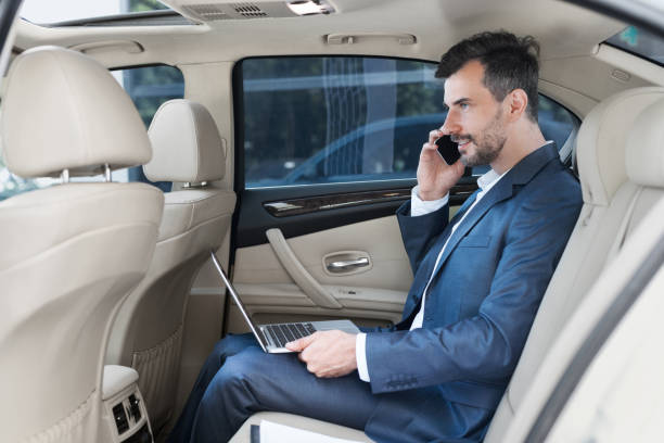 istock Always available. Businessman working on laptop in car 1084043180