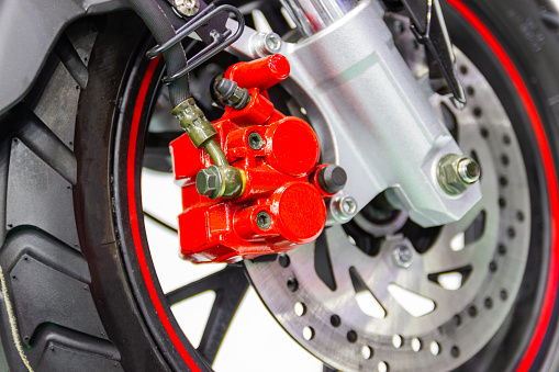 Close up motorcycle disc brake new modern red of Motorcycle, is brake system part of the motorcycle