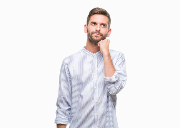 istock Young handsome man over isolated background with hand on chin thinking about question, pensive expression. Smiling with thoughtful face. Doubt concept. 1084051130
