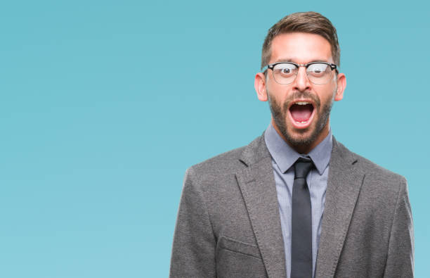 istock Young handsome business man over isolated background afraid and shocked with surprise expression, fear and excited face. 1084051168