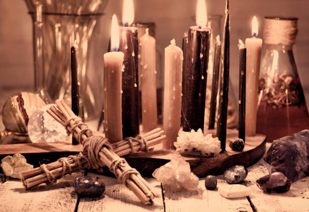 istock Vintage still life with cross, black candles, minerals and flasks on table 1084053208