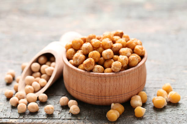 istock Roasted and dry chickpeas on gray wooden table 1084055014