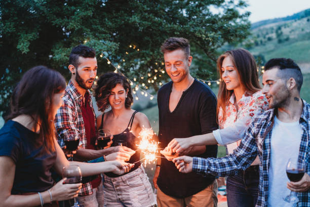 Happy friends having fun together with sparklers Happy friends having fun together with sparklers big family sunset stock pictures, royalty-free photos & images