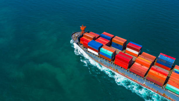 istock Container ship carrying container for import and export, Aerial view business logistic and freight transportation by ship in open sea. 1084057958