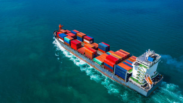 istock Container ship carrying container for import and export, Aerial view business logistic and freight transportation by ship in open sea. 1084057960