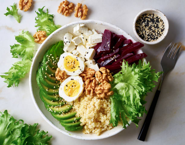 istock Buddha bowl, balanced food, vegetarian menu. Grey marble table, top view. Eggs, avocado, salad lettuce, bulgur, beetroot, tofu 1084060326