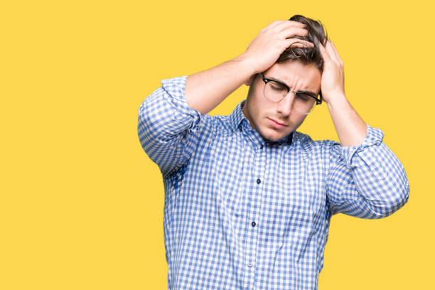 istock Young handsome man wearing glasses over isolated background suffering from headache desperate and stressed because pain and migraine. Hands on head. 1084060382