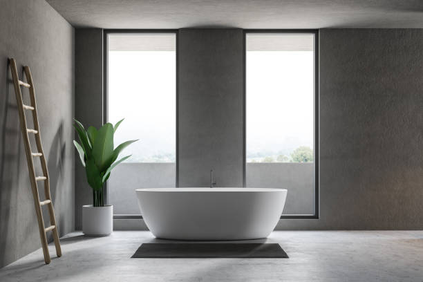 istock Gray bathroom interior with tub and ladder 1084062320