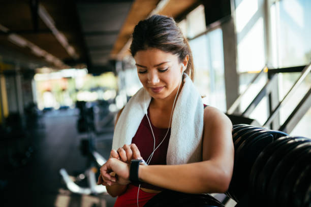 istock Athletic woman checking the time on wristwatch 1084066222