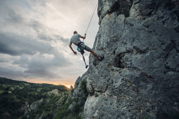 istock Disability man on free climbing adventure 1084066254