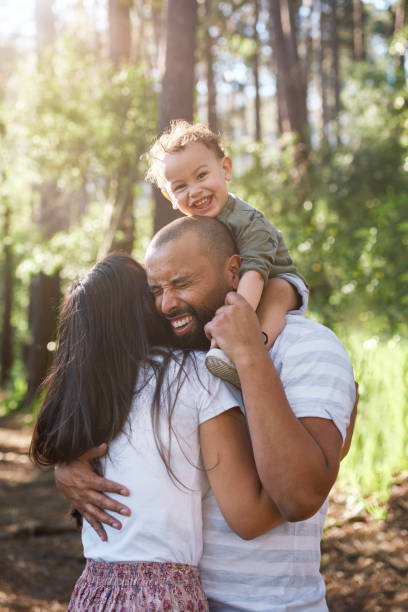 istock laughing dad and mom hug 1084071310