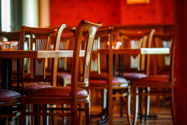 istock Wooden chairs put up against tables in an empty cafe 1084083278