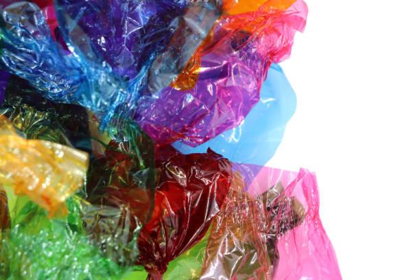 istock Coloured sweet wrappers on white background with copy space 1084085436