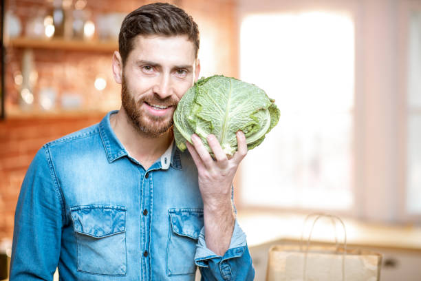 istock Man with green food on the kitchen 1084087828