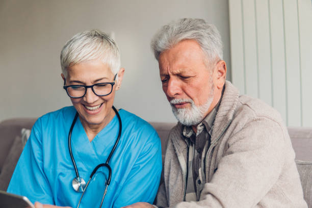 istock Nurse and patient looking at digital tablet 1084088064
