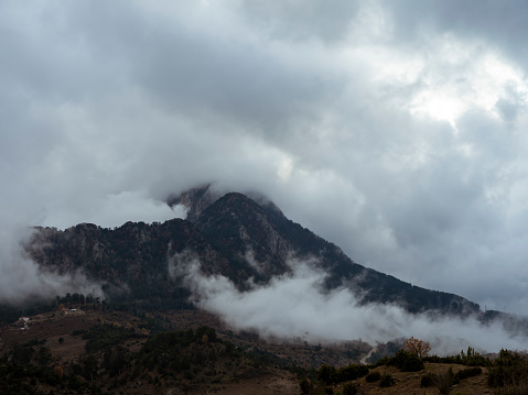 A mountain covered with clouds and fog.