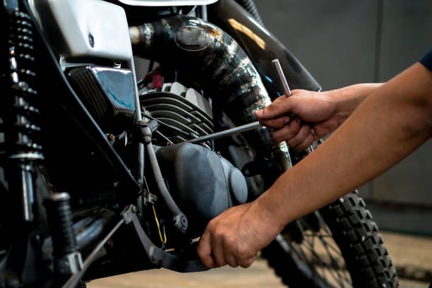 People are repairing a motorcycle. Image is Close up,People are repairing a motorcycle Use a wrench and a screwdriver to work. used motorcycle parts stock pictures, royalty-free photos & images