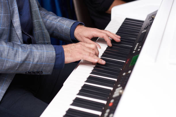 istock man playing the piano, close-up, hands 1084093044