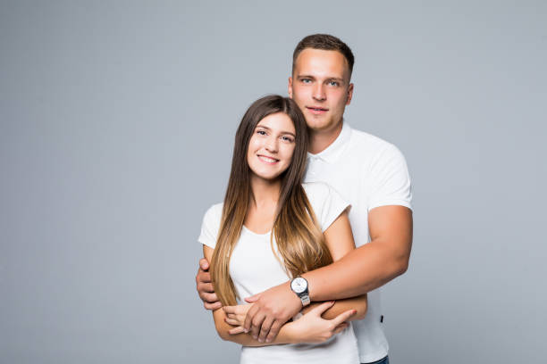istock Young happy couple hugging and possing isolated gray background 1084093228