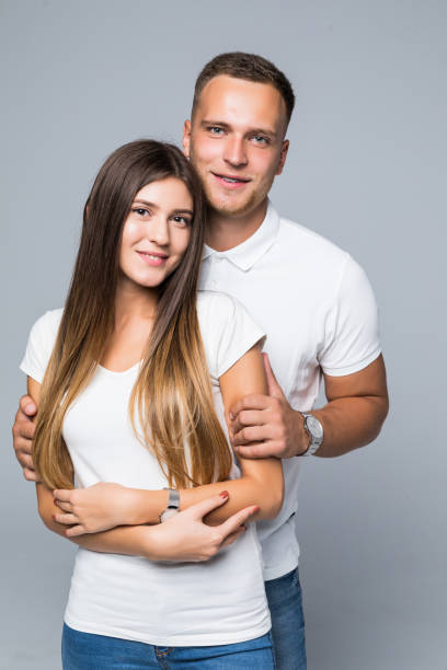 istock Young happy couple hugging and possing isolated gray background 1084094914