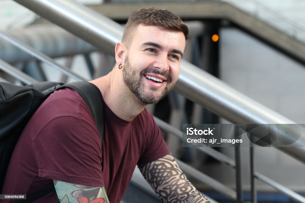 Cool male student smiling with copy space Cool male student smiling with copy space. Tattoo Stock Photo