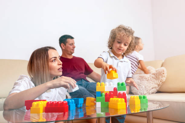 istock Family - man working with computer while looking after his daughter. 1084096206