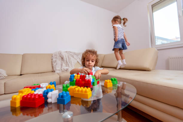 istock Family - man working with computer while looking after his daughter. 1084097448