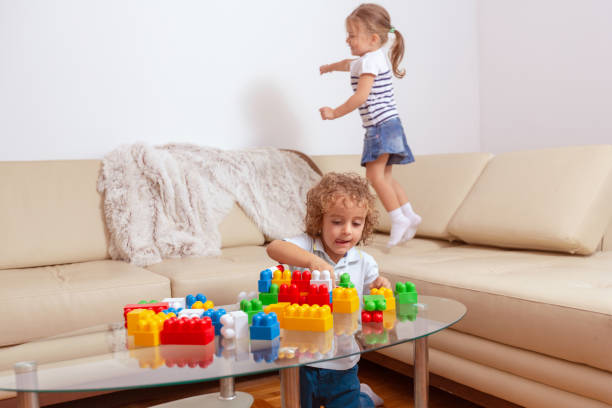 istock Family - man working with computer while looking after his daughter. 1084097542