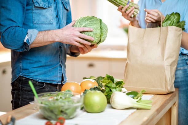 istock Couple with healthy food on the kitchen 1084097590