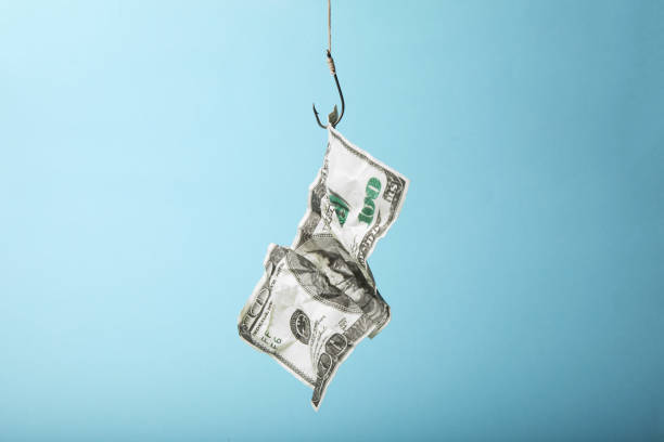 istock Hundred dollars on hook is trap. Dependence on loans and credits 1084097620
