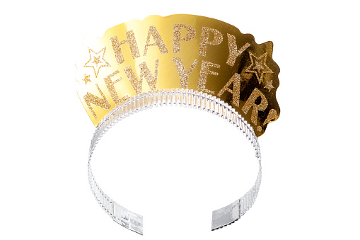 Happy new year and new years eve party accessories concept with a gold headpiece or tiara made of paper and covered in shiny glitter isolated on white background with a clipping path cut out