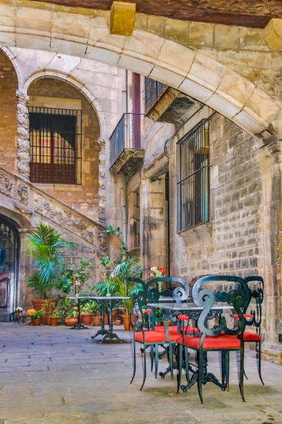 Antique building courtyard converted in picturesque restaurant at gothic district in barcelona city, Spain.