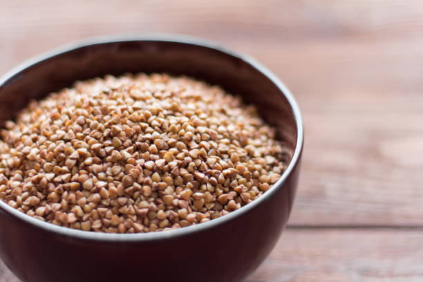 istock buckwheat in a bowl on a wooden background, selective focus 1084100234