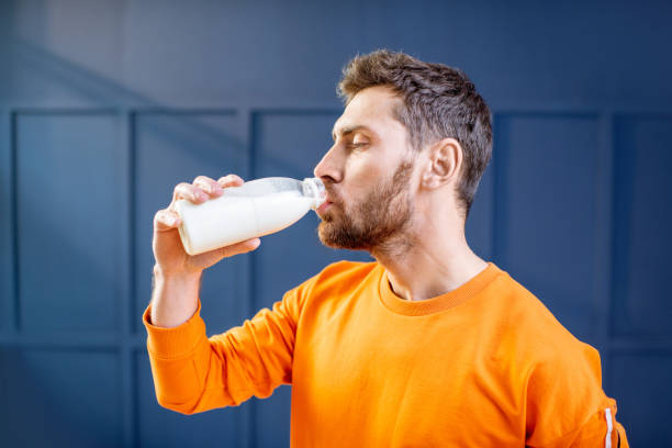 Sports man drinking milk